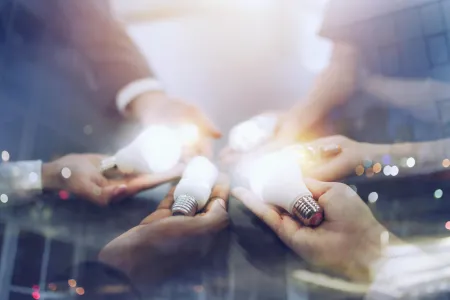 Hands holding lightbulbs